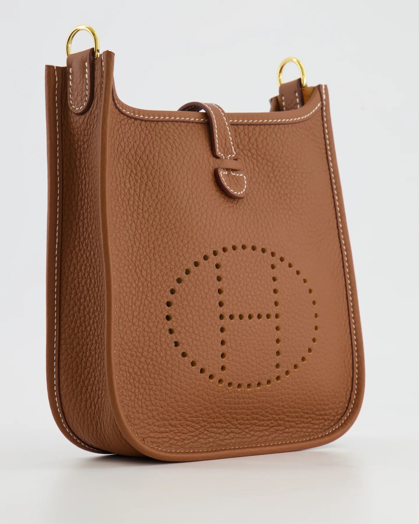 Close-up of Gold Clemence leather on a Hermès Mini Evelyne handbag.