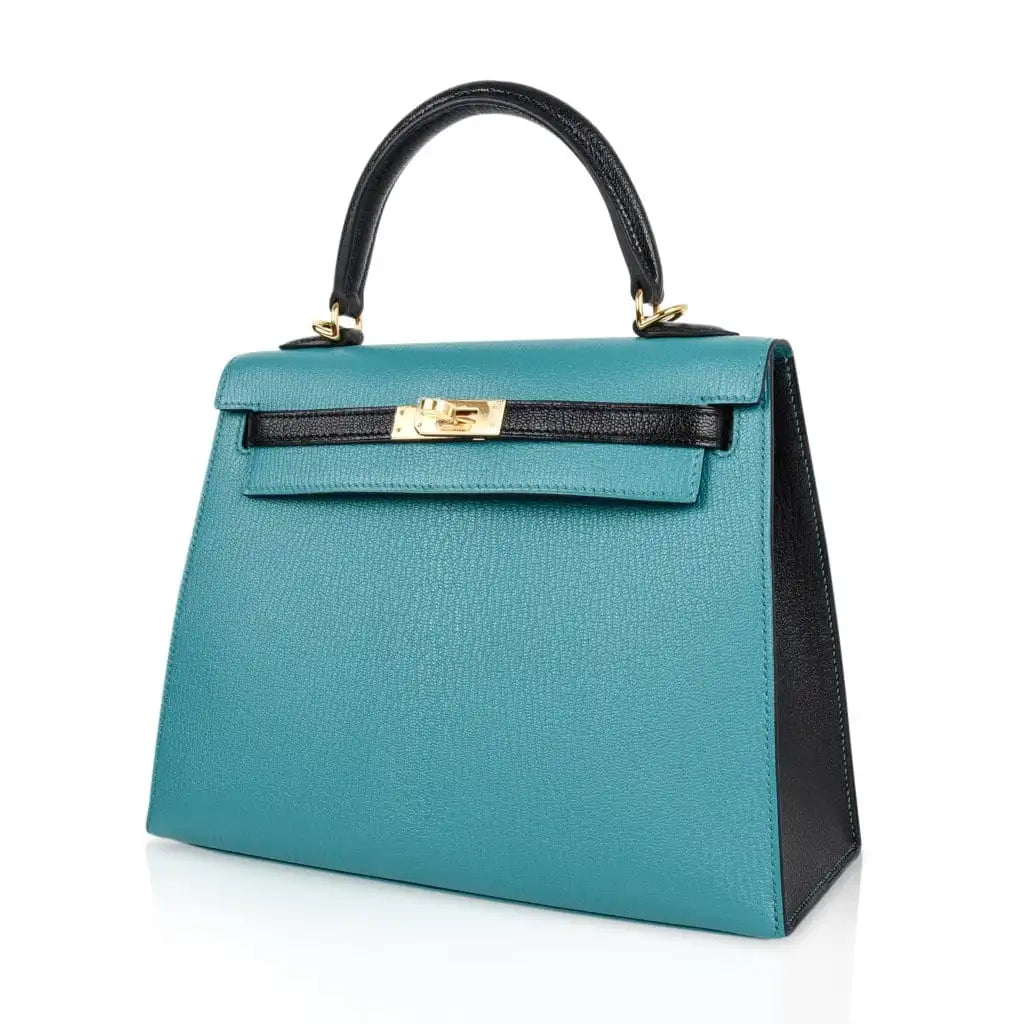 Side view of blue hermes kelly gold hardware handbag
