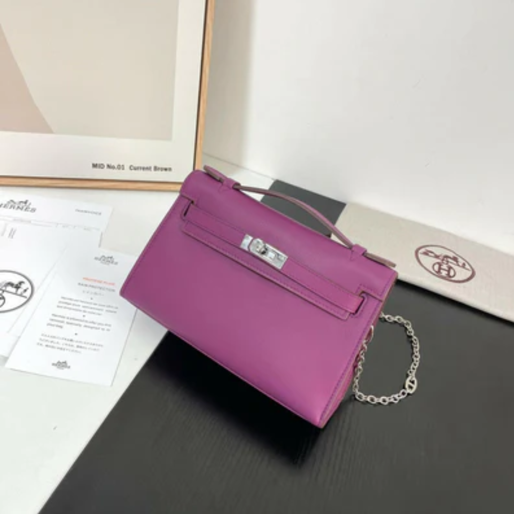 Women's leather baguette handbag in  purple with a sleek, rectangular silhouette.