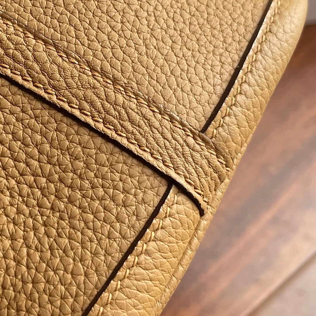 Mini leather coin purse keychain detail highlighting the rich texture of the genuine leather.